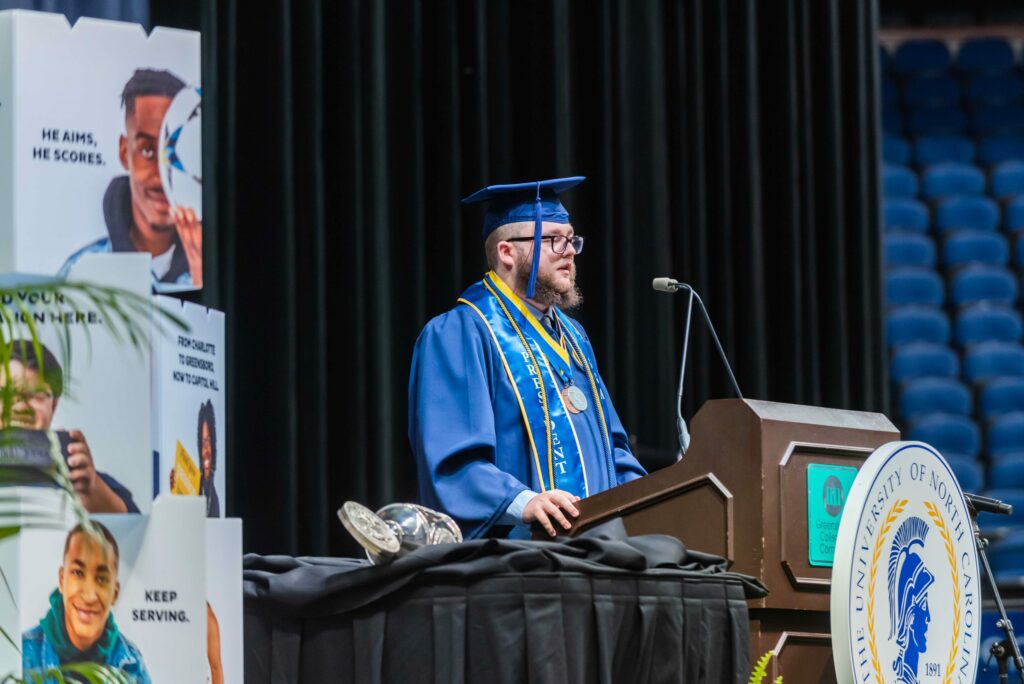Graduate speaking at podium