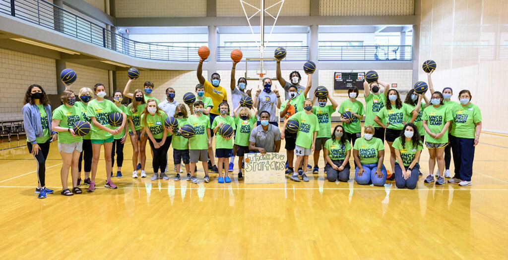 Group photo of people holding basketballs