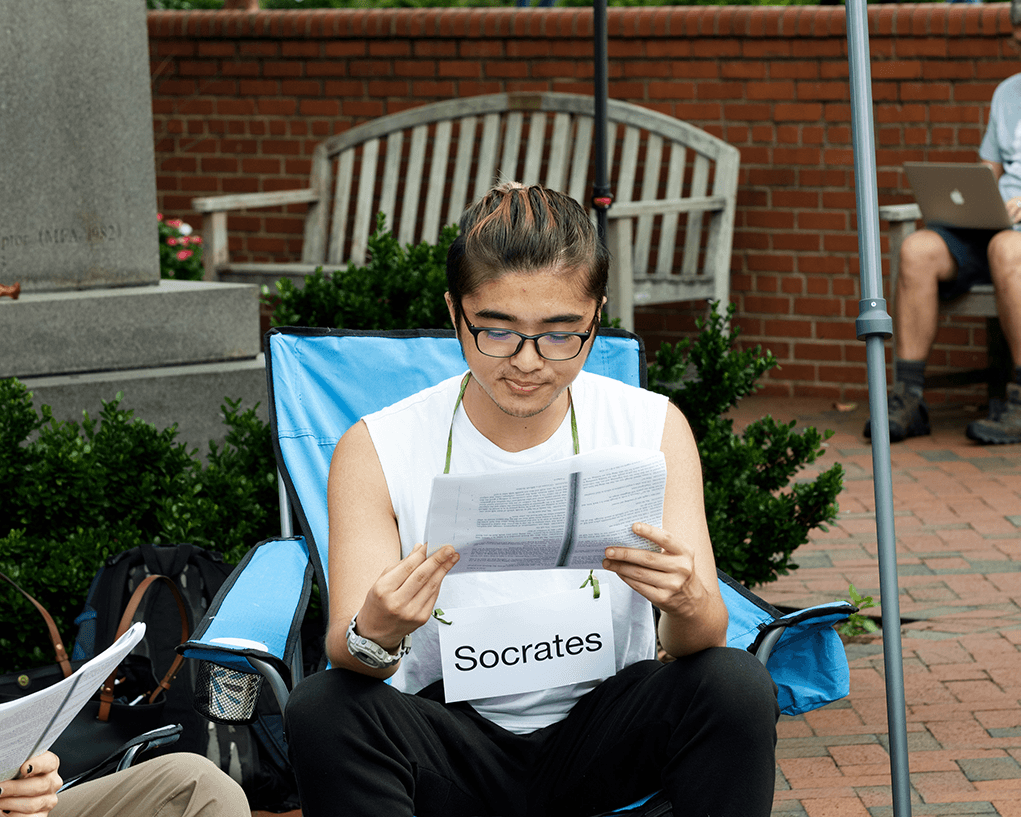 Student sits in lawnchair reading