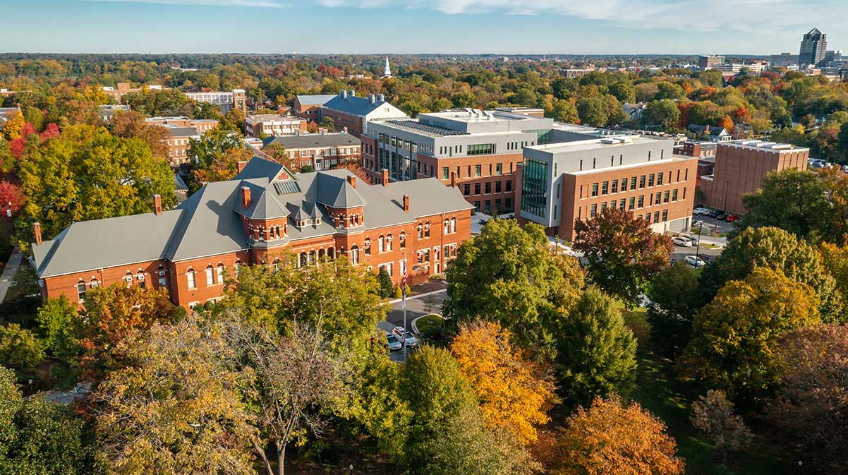 Drone shot of Foust Building surrounded by Autumn trees