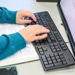 female hands typing on a computer keypad