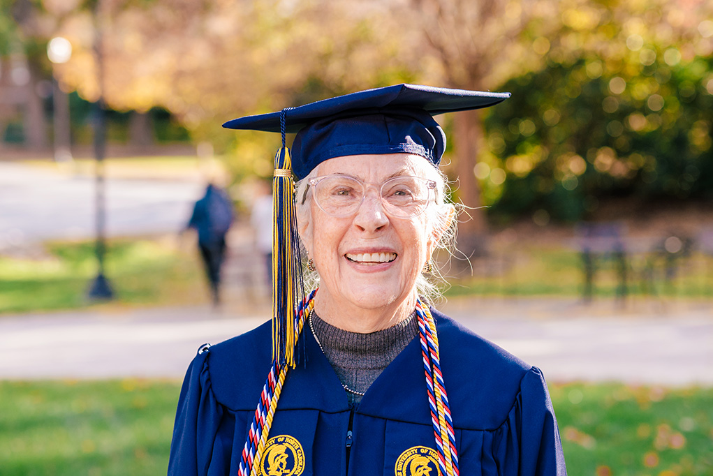 Bonnie Miller smiles in cap and gown