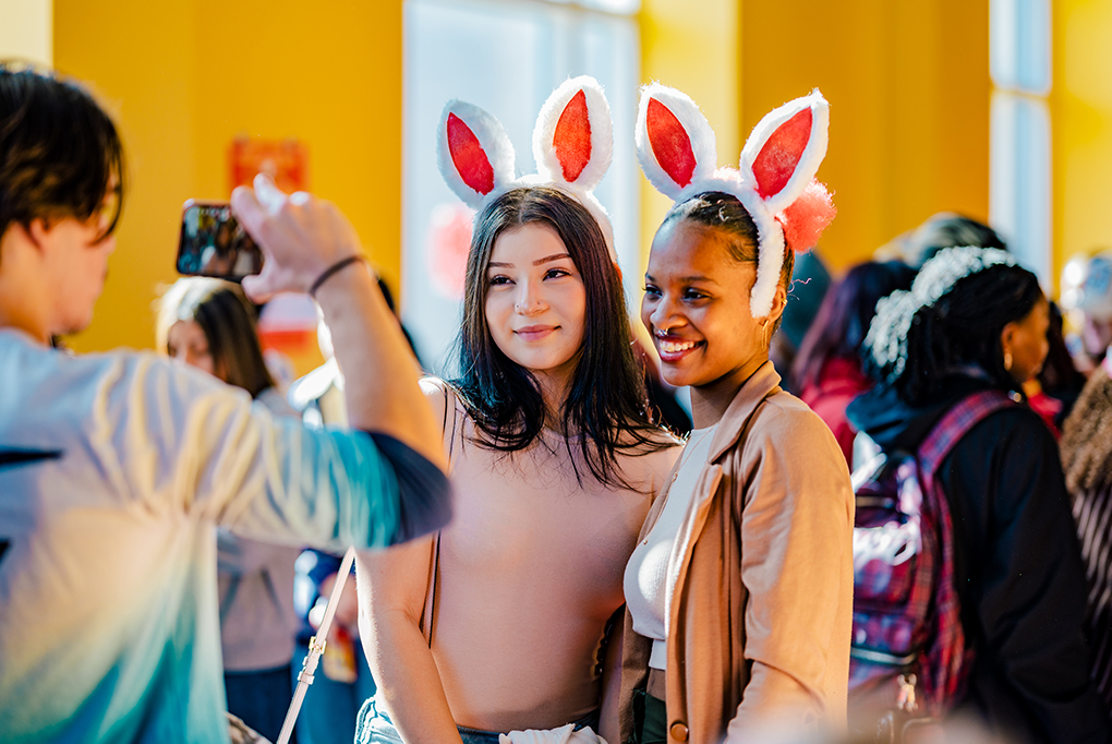 two students with bunny ears