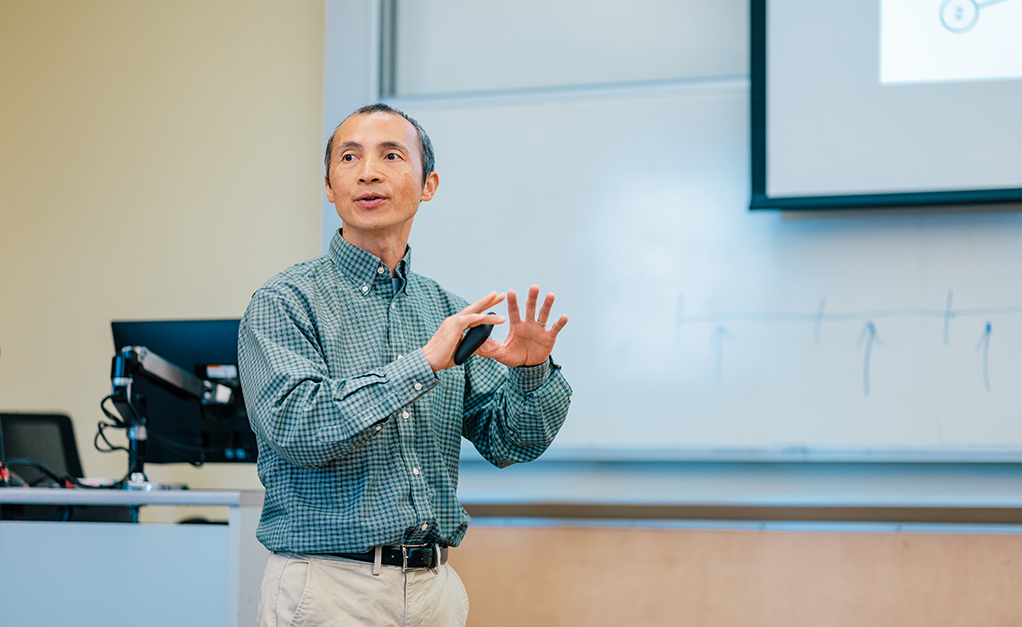 Jing Deng teaching with hands gesturing