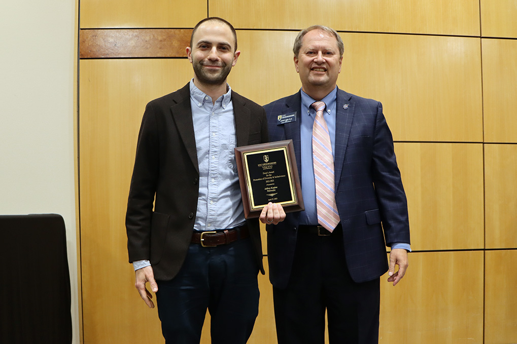 Jeffrey Kaplan and Dean John Z. Kiss at the 2022-2023 End of Year Celebration, holding the award for the Promotion of Diversity and Inclusiveness.