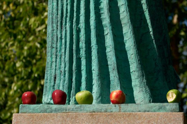 base of the Minerva statue, with apples seated on the platform