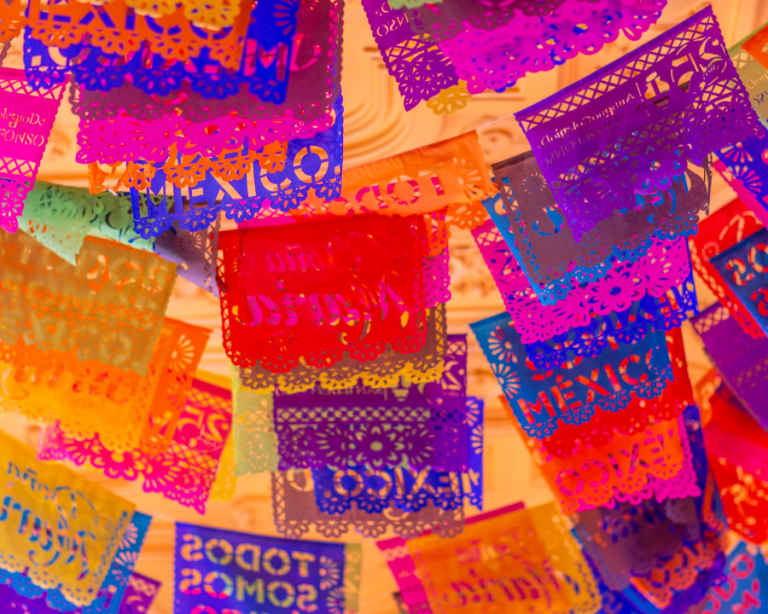 colorful draped cutout flags bearing the word MEXICO