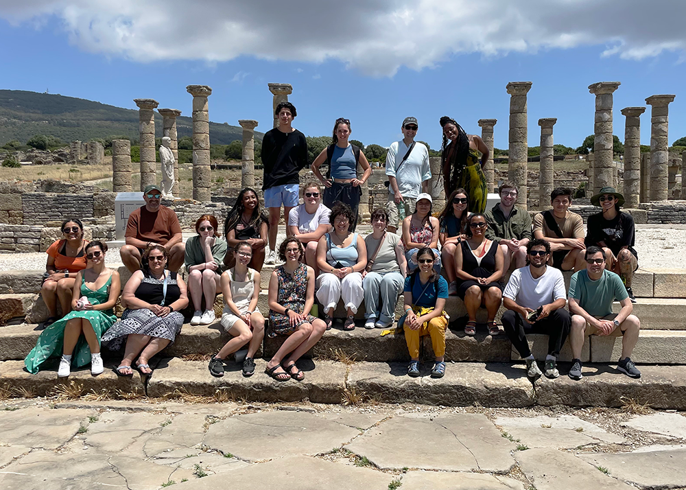 group of students and teachers in front of Roman ruins