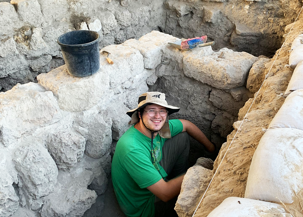 Student excavating in ruins