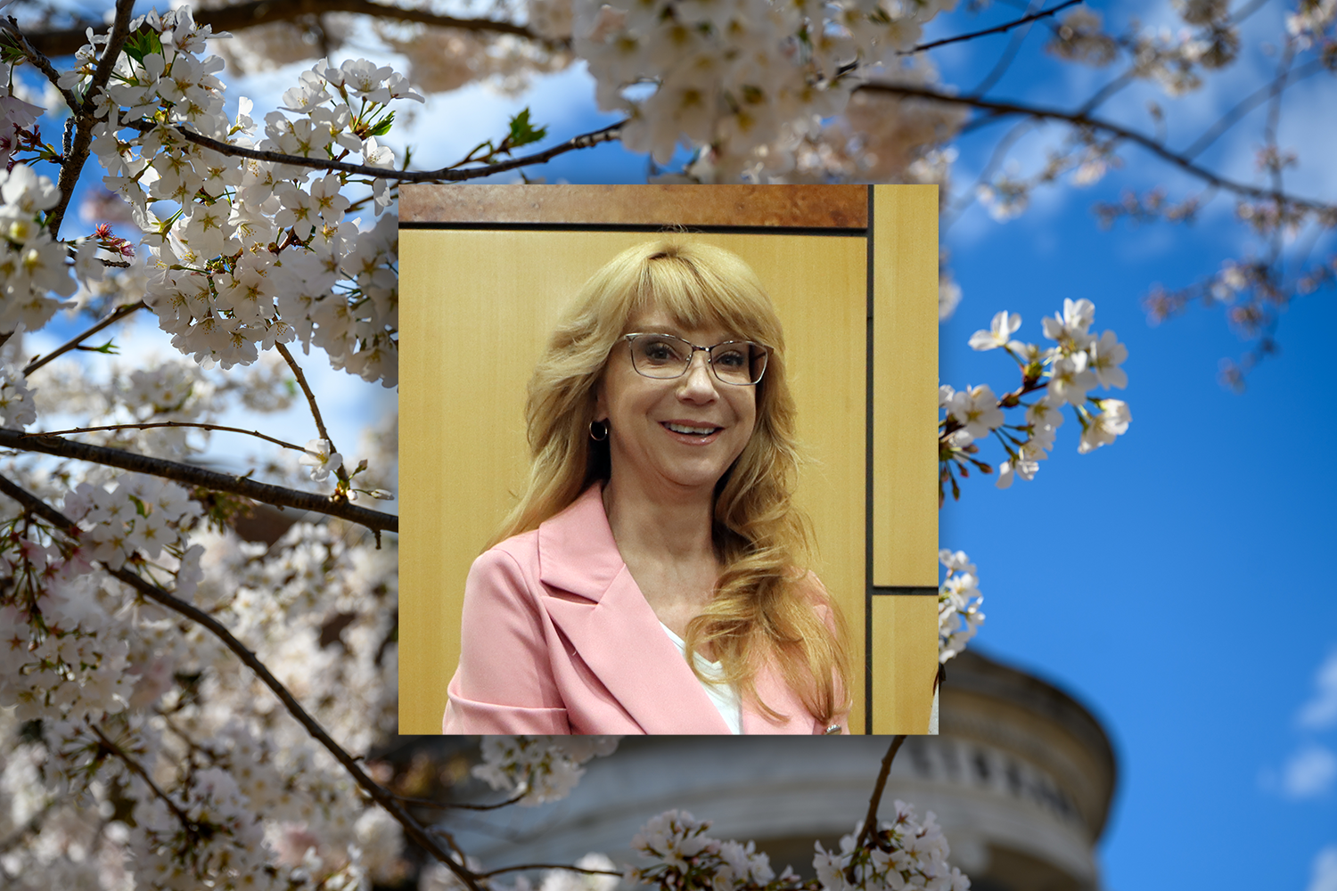 Kimberlianne Podlas with background of flowers on campus