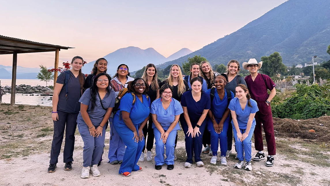 Group of people in scrubs in Guatemala in front of mountains