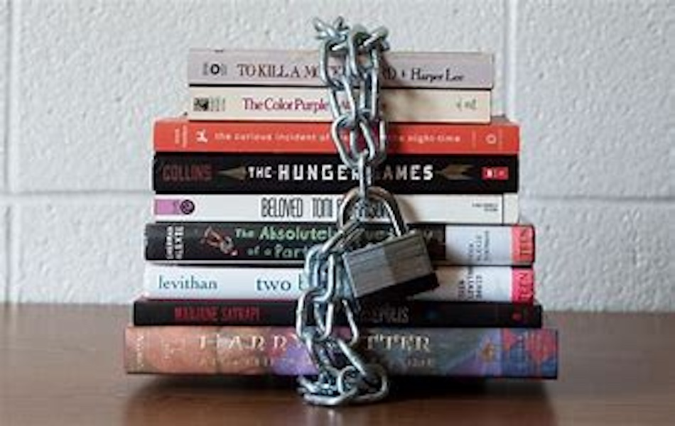 picture of books bounded together by a metal chain and lock