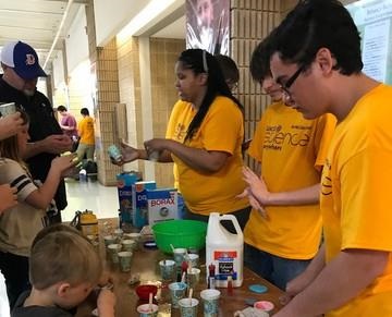 picture of SciEverywhere volunteers making slime with attendees