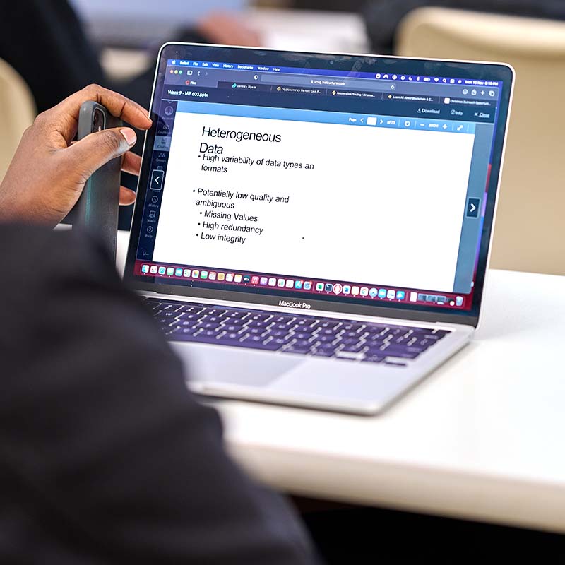 Student hand in front of computer screen with "Heterogenous data" powerpoint slide showing