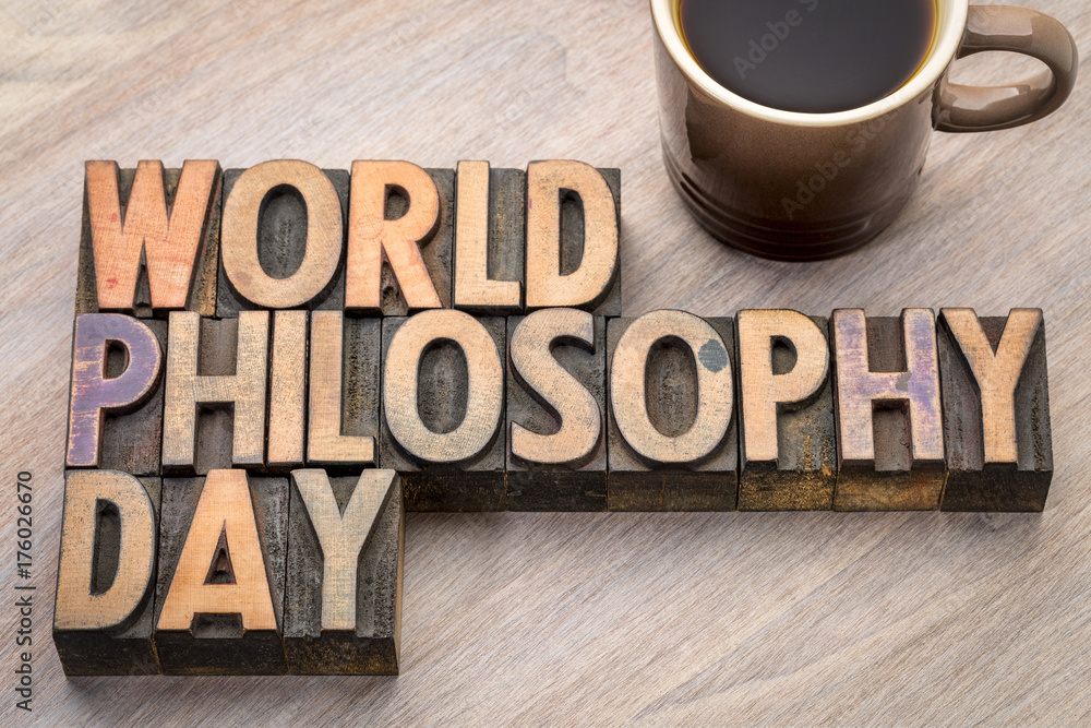 the phrase "World Philosophy Day" made out of wooden blocks on a table