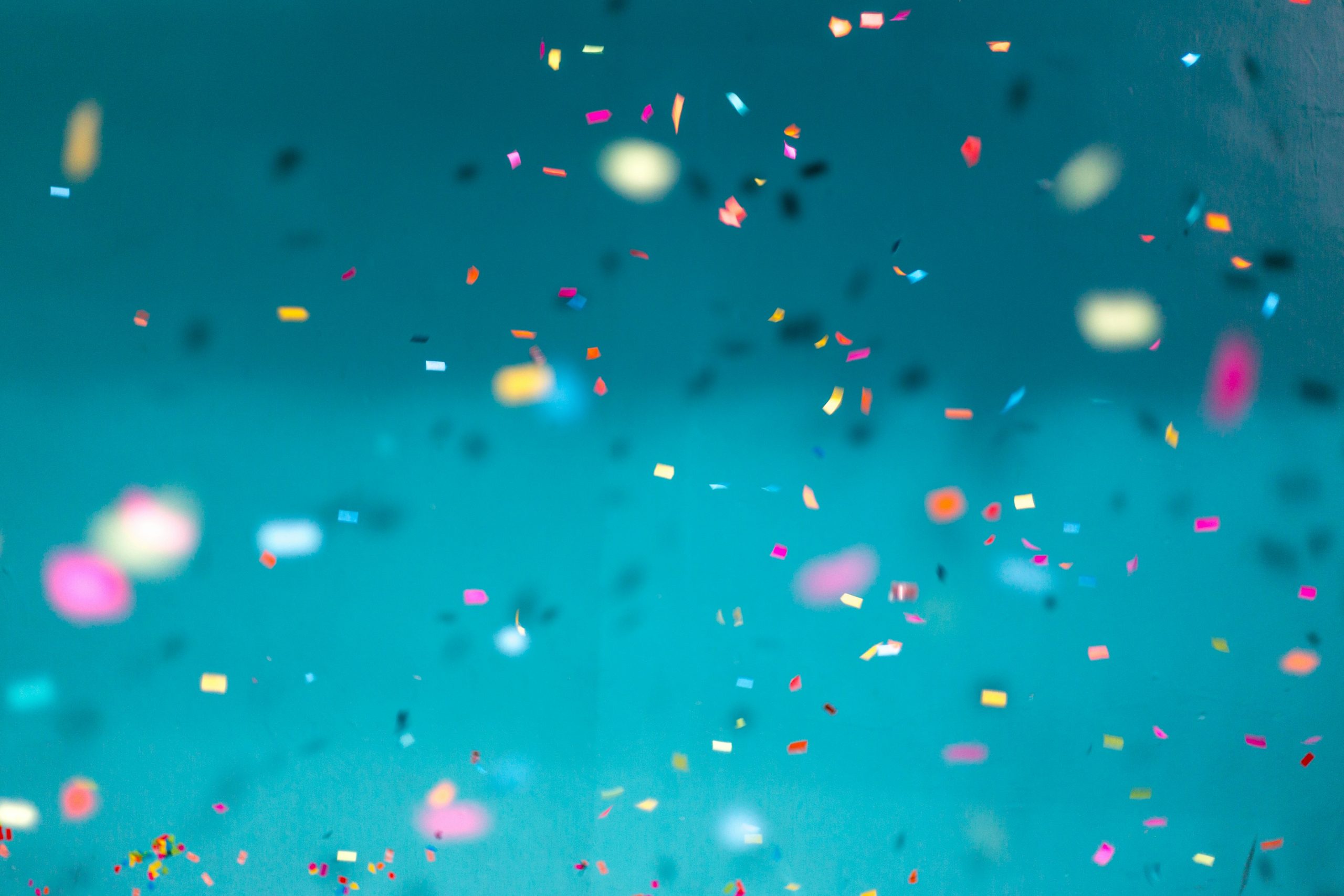 Colorful confetti falling on a blue background