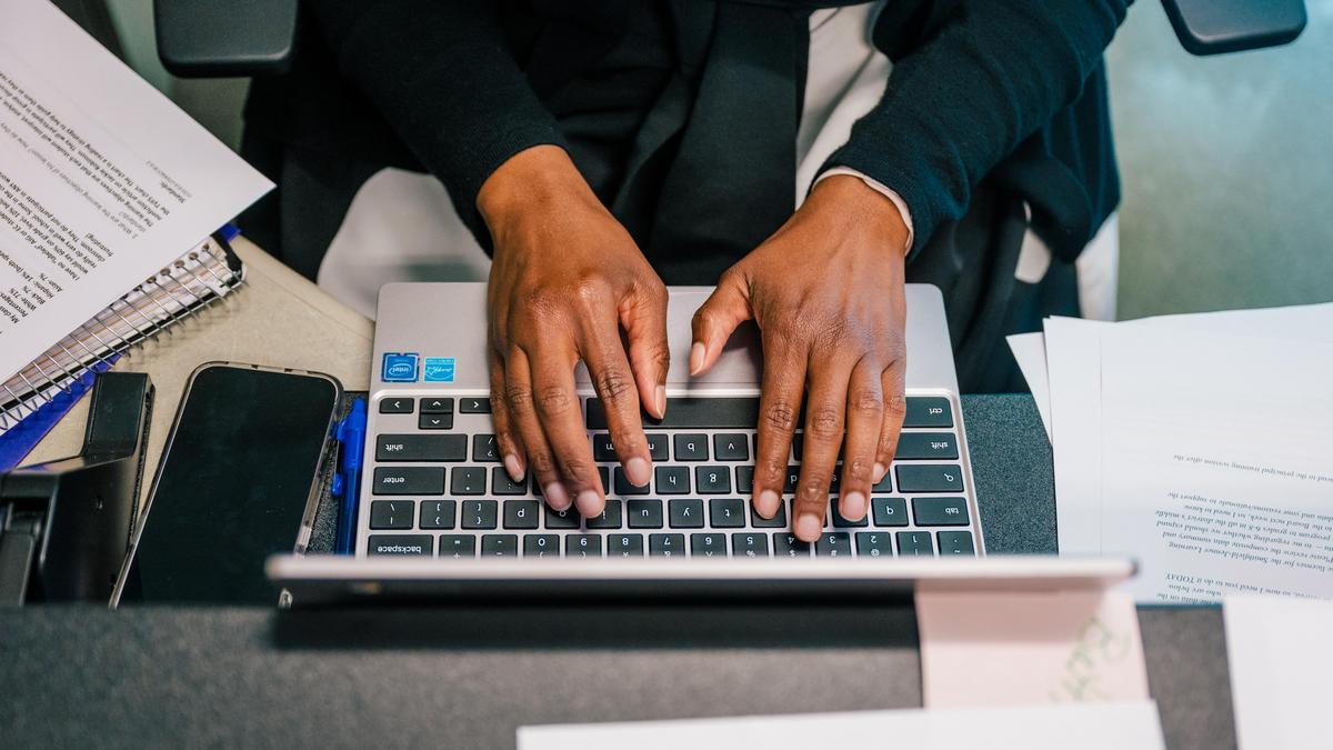 hands on laptop keyboard