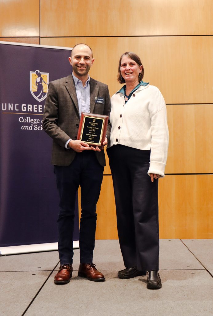 Dean Kelly Joyce (right) poses with Associate Professor Jeffrey Kaplan after honoring him with the College of Arts & Sciences Teaching Excellence Award for a  
Tenured faculty member
