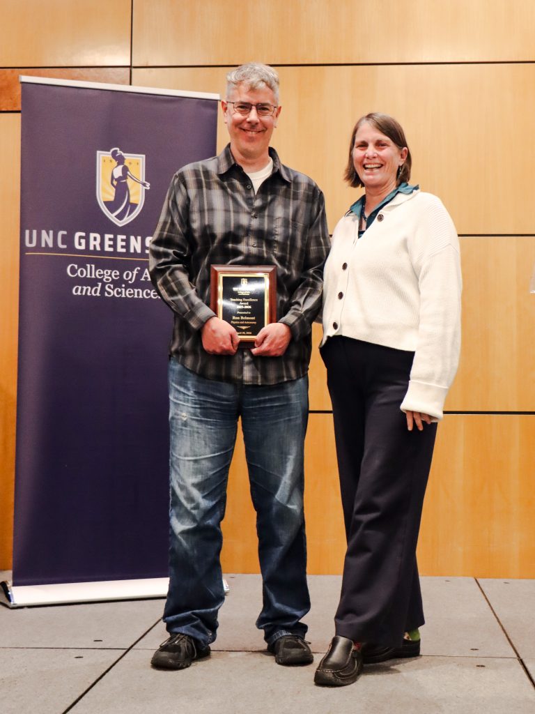 Dean Kelly Joyce (right) poses with Assistant Professor Ron Belmont (left) after honoring him with the College of Arts & Sciences Teaching Excellence Award for a Tenure-track faculty member
