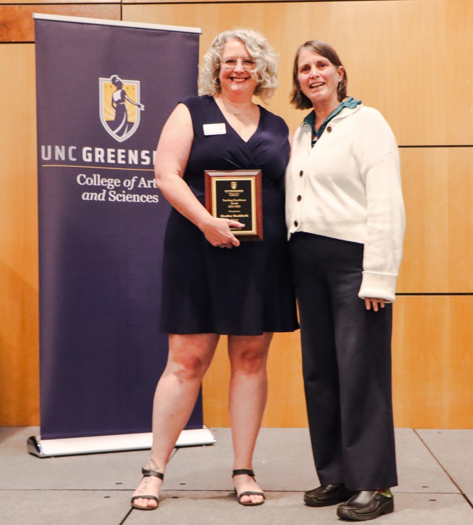 Dean Kelly Joyce (right) poses with Senior Lecturer Heather Rushforth (left) after honoring her with the College of Arts & Sciences Teaching Excellence Award  for a Professional Track faculty member