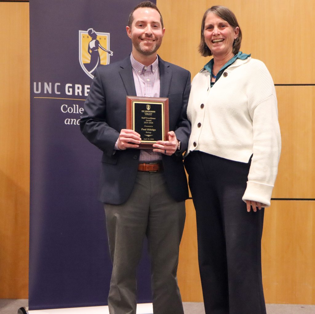 Dean Kelly Joyce (right) poses with Business Officer Paul Hidalgo (left) after honoring him with a Staff Excellence Award
