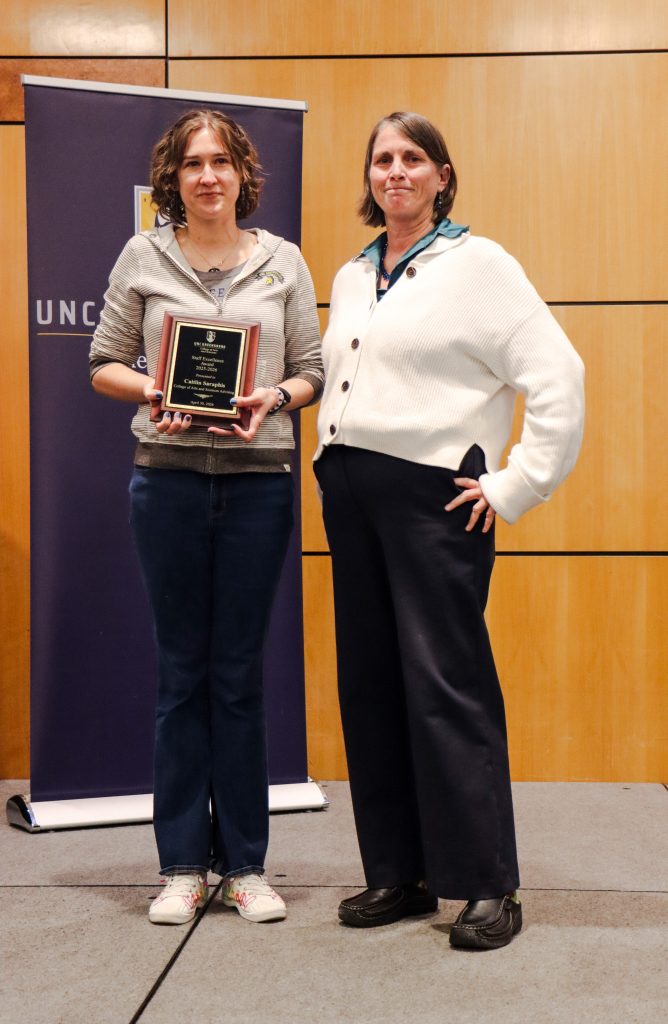 Dean Kelly Joyce (right) poses with Associate Director of CASA Caitlin Saraphis (left) after honoring her with a Staff Excellence Award