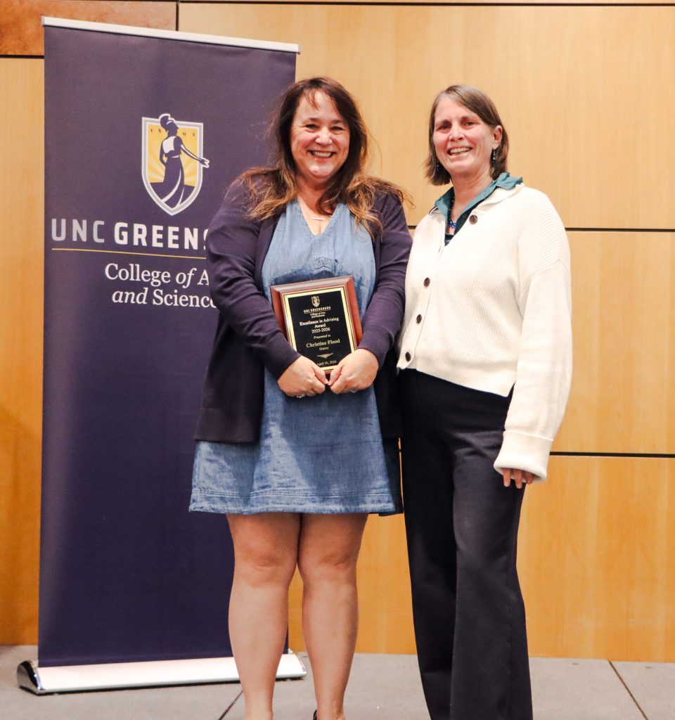 Dean Joyce (right) poses with Academic Profession and Director Christine Flood (left) after honoring her with a College of Arts & Sciences Advising Excellence Award