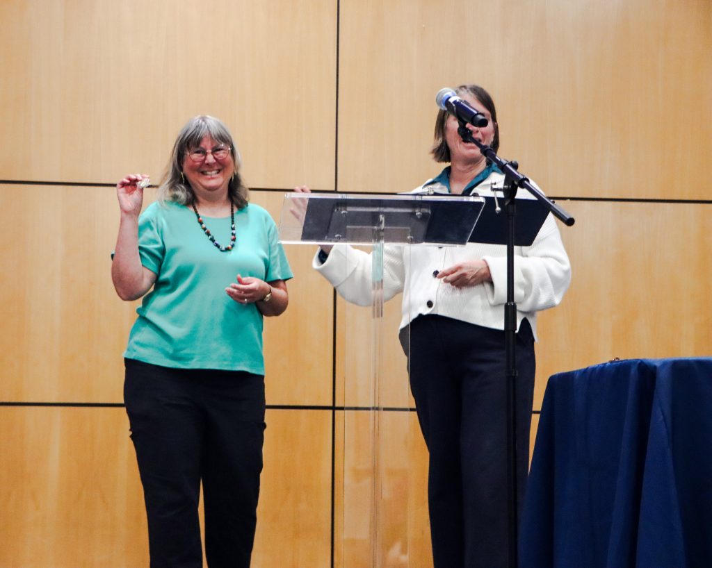 Chief of Staff Lori Wright (left) receives her pin for 30 years of service.