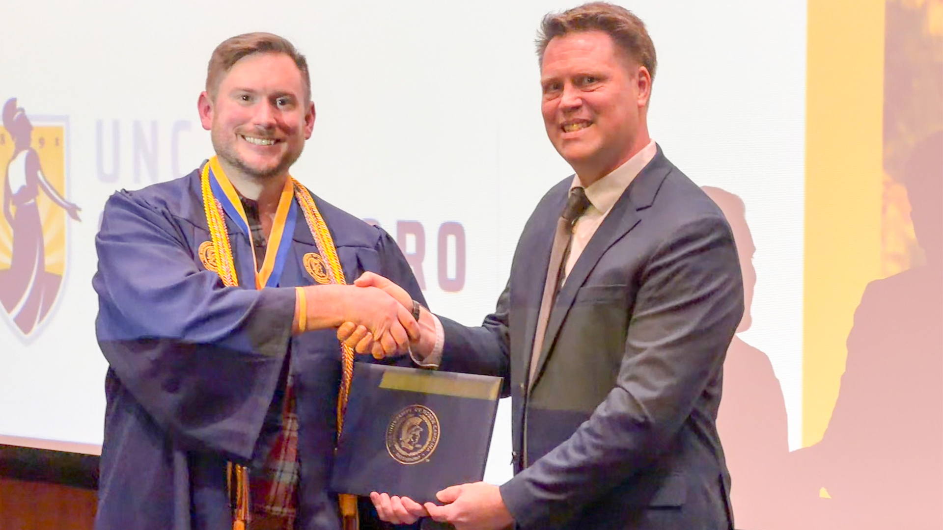 Jason Rich poses with Interior Architecture Department Head Travis Hicks at the department recognition ceremony.